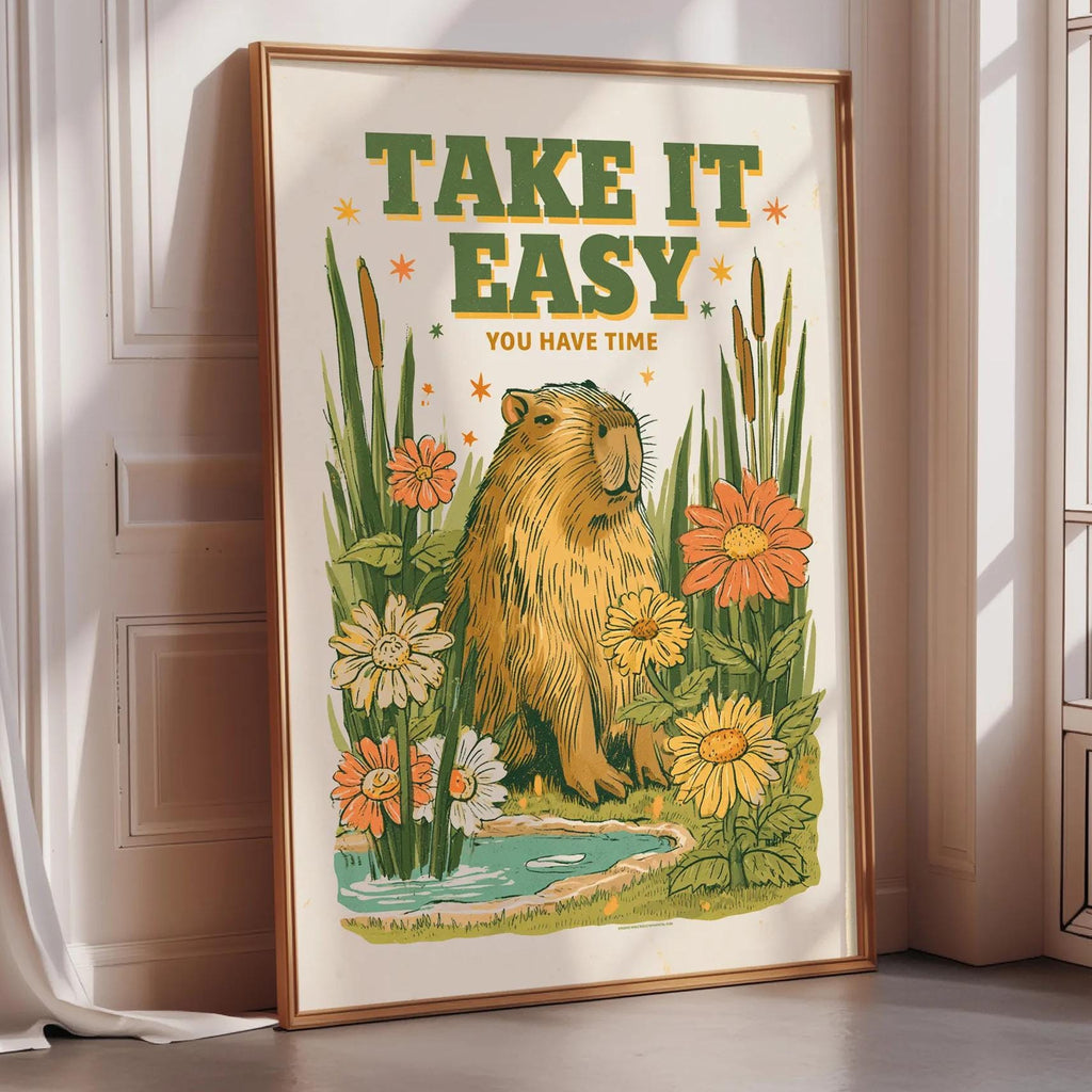 a framed poster with a beaver surrounded by flowers and plants, with the text "TAKE IT EASY YOU HAVE TIME" displayed prominently.