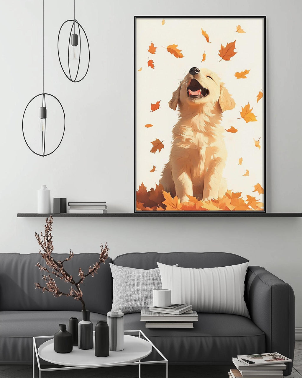 a cozy living room with a gray couch, a coffee table, and a large framed picture of a golden retriever dog sitting on a pile of autumn leaves. The room has a minimalist and modern design, with a black pendant light hanging above the couch and a shelf displaying various decorative items.