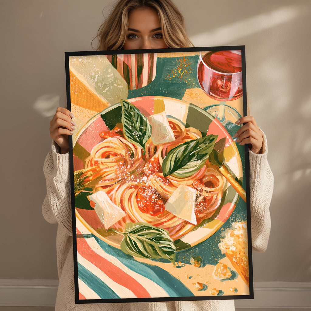 A woman holds up a framed painting of a colorful pasta dish with a glass of wine.