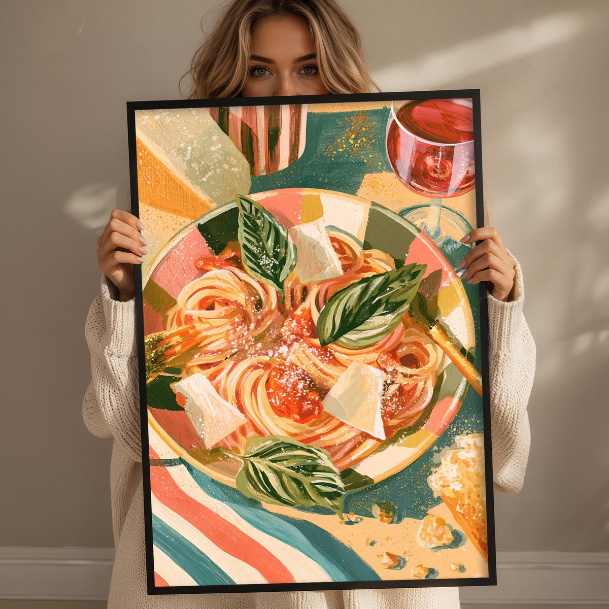A woman holds up a framed painting of a colorful pasta dish with a glass of wine.