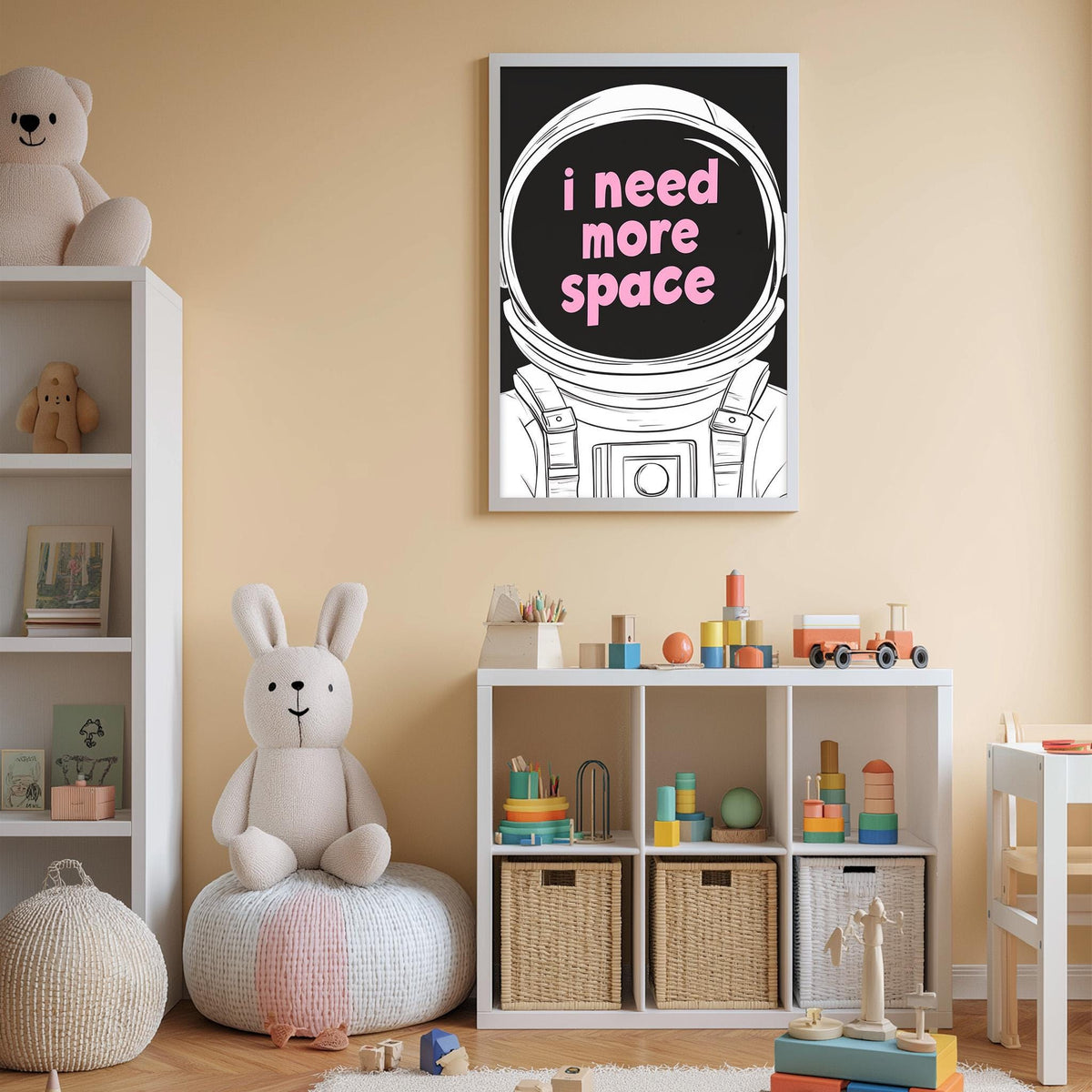 A child's bedroom with a stuffed rabbit, a bookshelf, and a poster with the text "I need more space" on the wall.