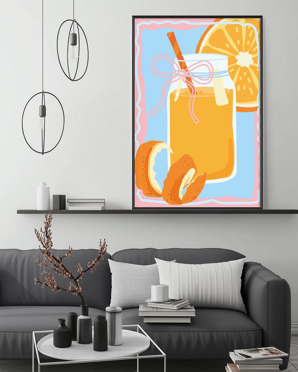 a modern living room with a gray sofa, a coffee table, and a large framed illustration of a glass jar filled with orange juice and a slice of orange on the wall above the sofa.