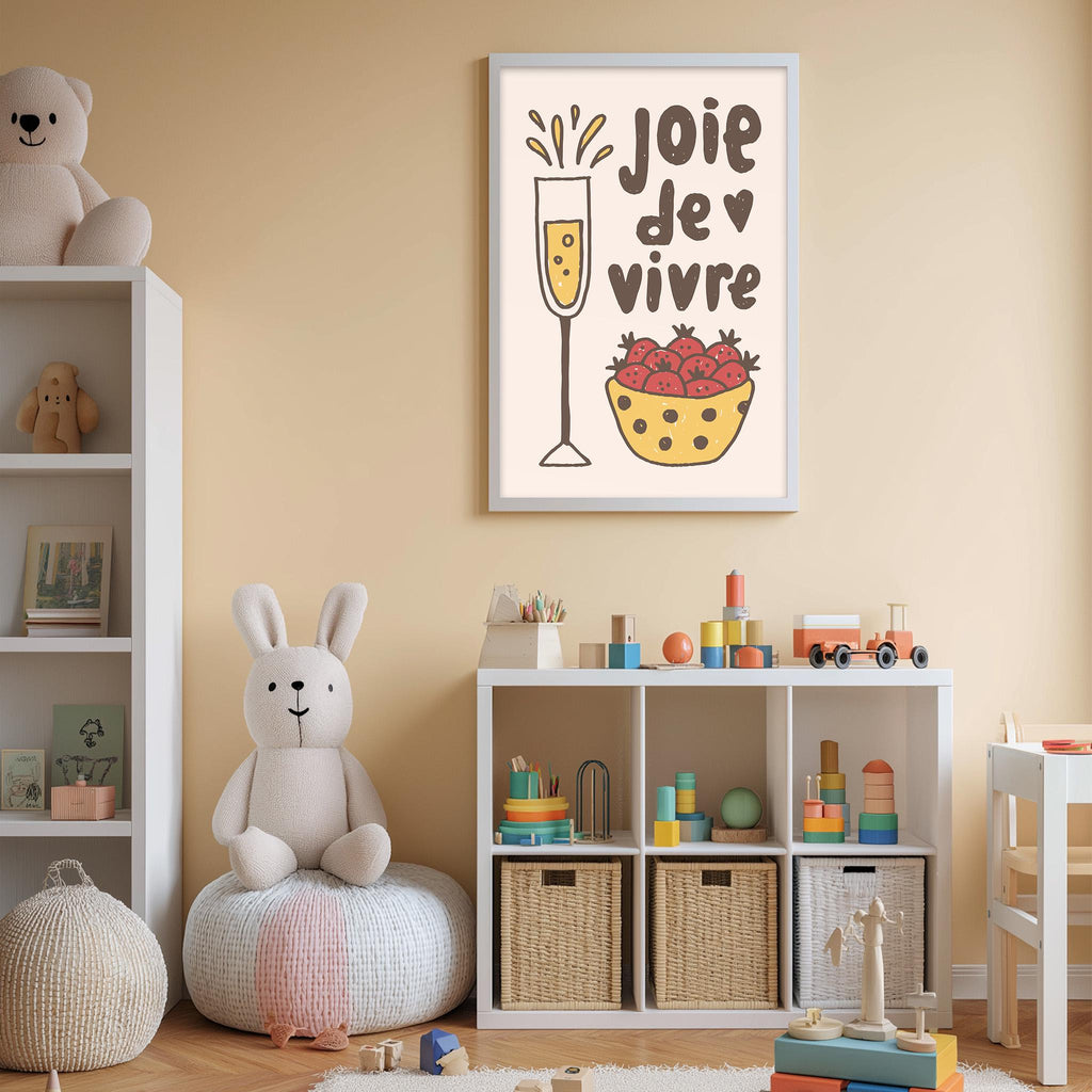 A child's bedroom with a white bookshelf, a stuffed rabbit, and a toy train. Above the bookshelf is a framed poster with a cartoon illustration of a wine glass and a bowl of strawberries.