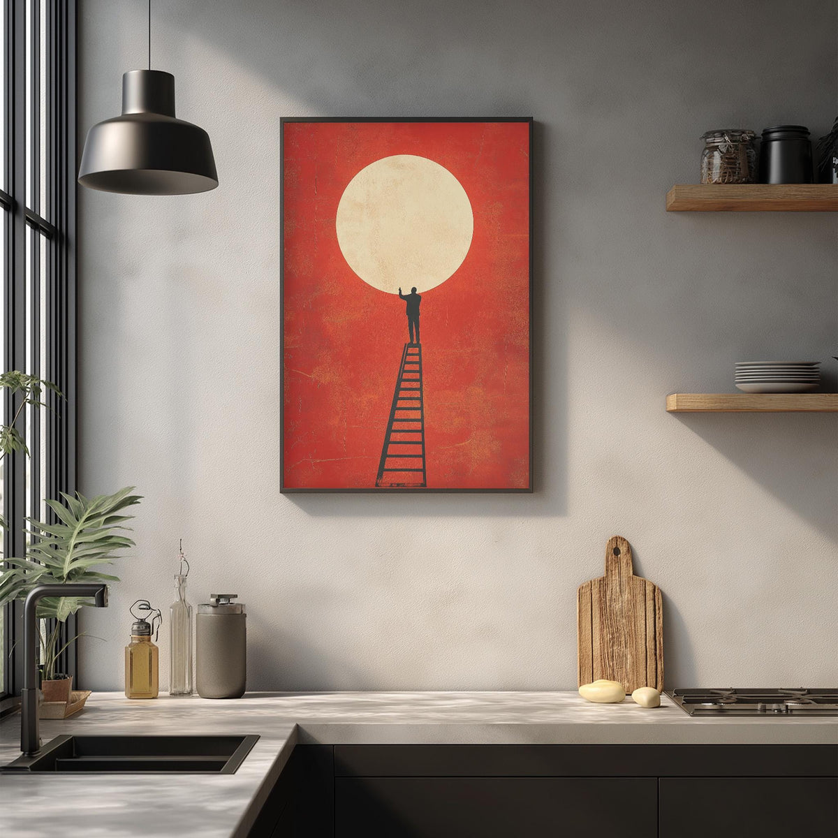a kitchen counter with a wooden cutting board, a metal container, and a glass bottle. Above the counter, there is a framed artwork depicting a person climbing a ladder towards a large white circle, which appears to be a sun or moon.
