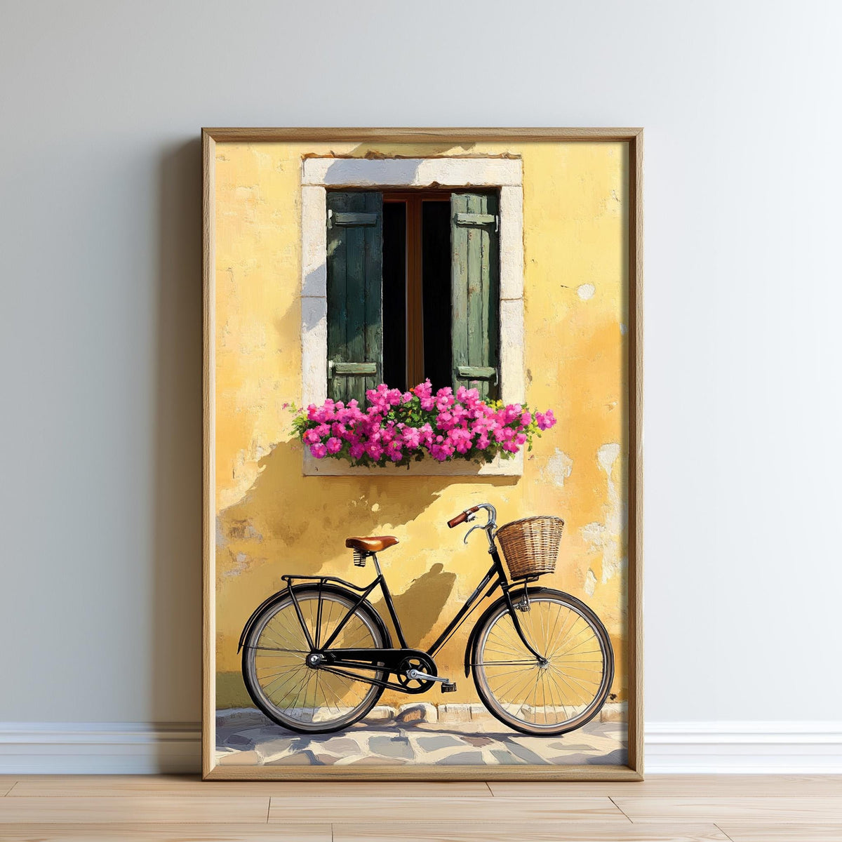 A framed painting depicting a bicycle parked in front of a yellow building with a window and flower box, set against a white wall.