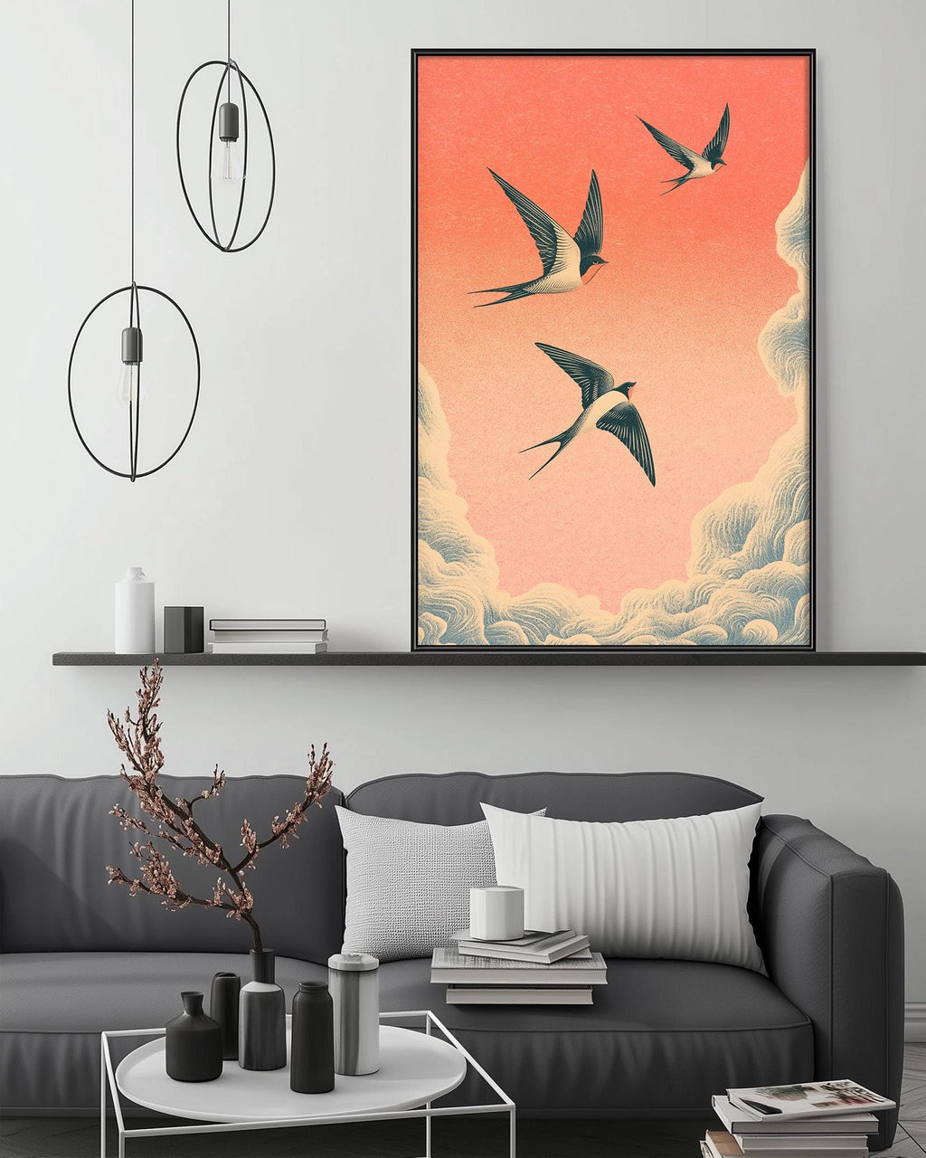 a modern living room with a gray sofa, a coffee table, and a large framed artwork depicting three birds flying in the sky above a cloud-filled background.