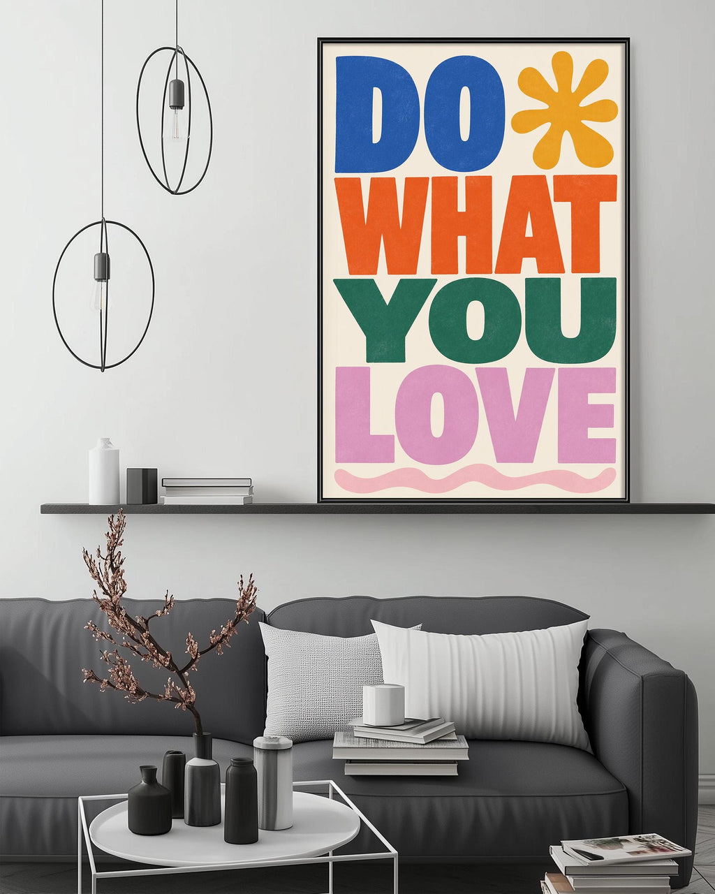 a modern living room with a gray sofa, a coffee table, and a large framed poster with the text "DO WHAT YOU LOVE" displayed on the wall above the sofa.