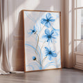 a large framed artwork depicting blue flowers on a white background.