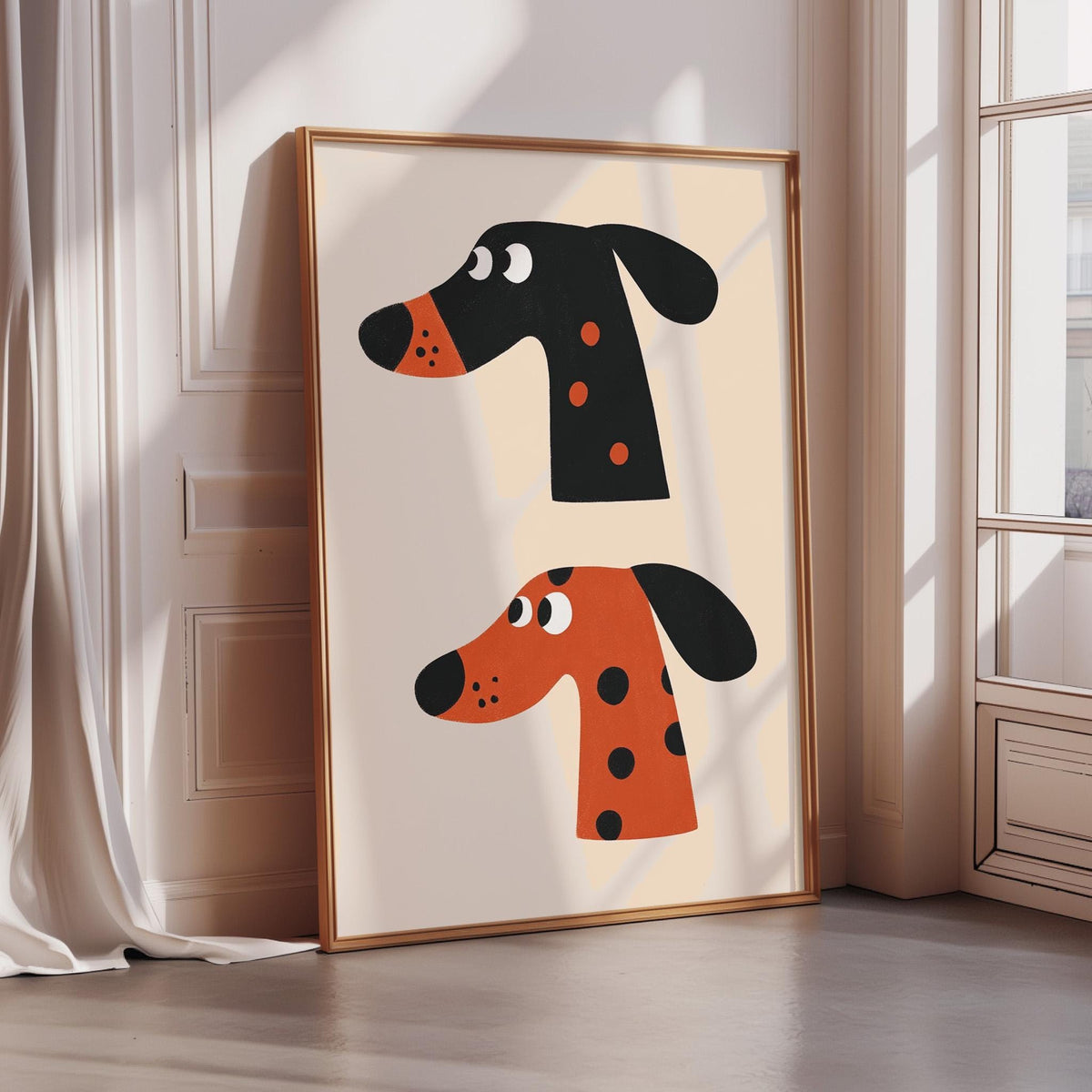 two stylized dog heads, one black and one orange, displayed in a framed artwork on a wall.
