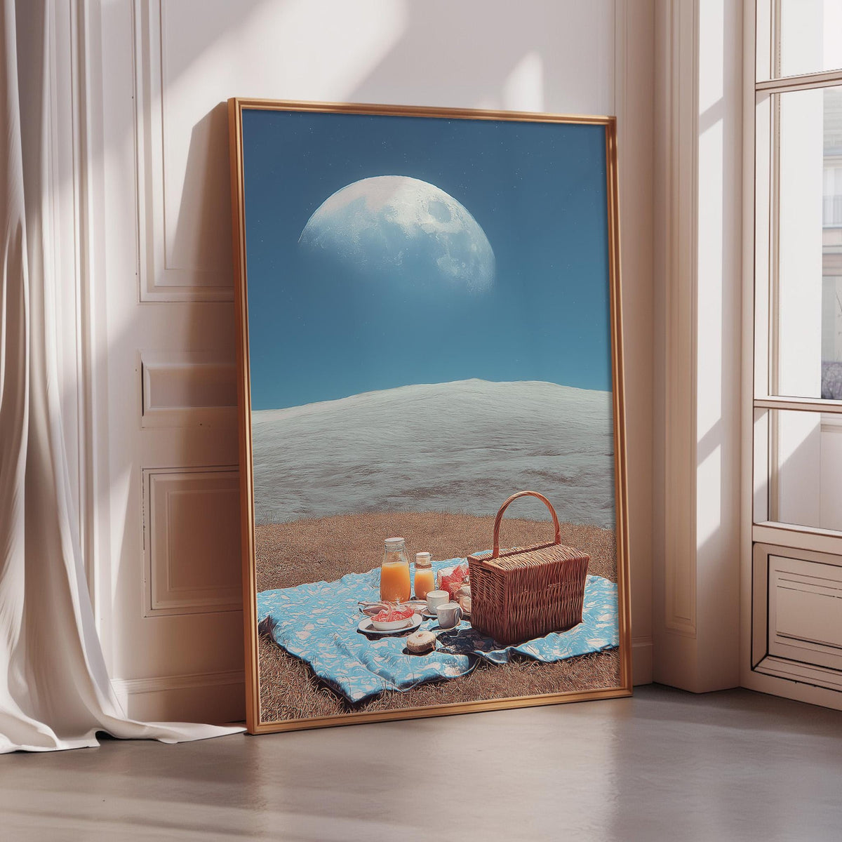 A large framed picture depicting a picnic scene with a basket, food, and drinks on a blanket, set against a backdrop of a moon and a blue sky.