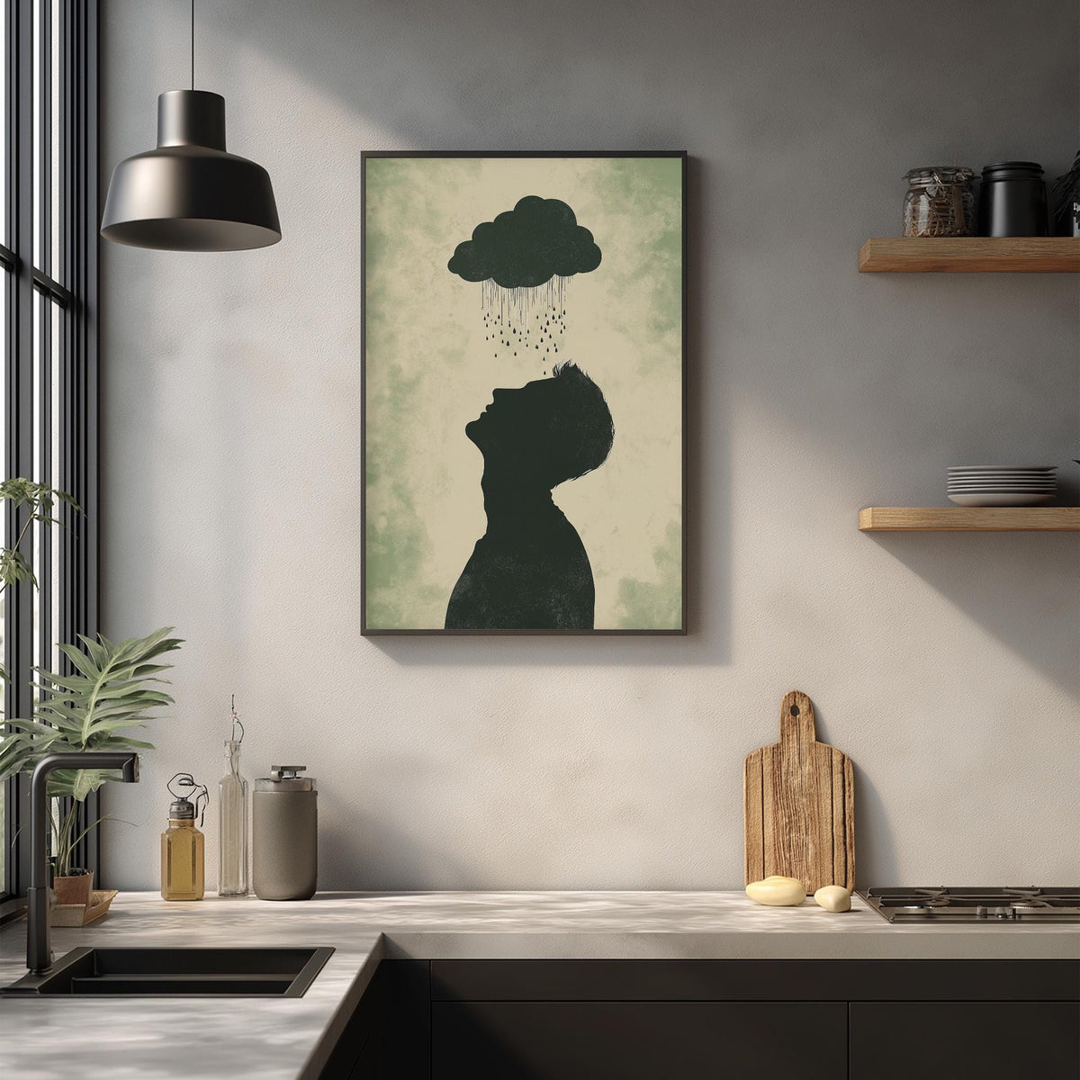a kitchen counter with various items on it, including a framed artwork depicting a silhouette of a person with a cloud above their head, a wooden cutting board, and a potted plant.
