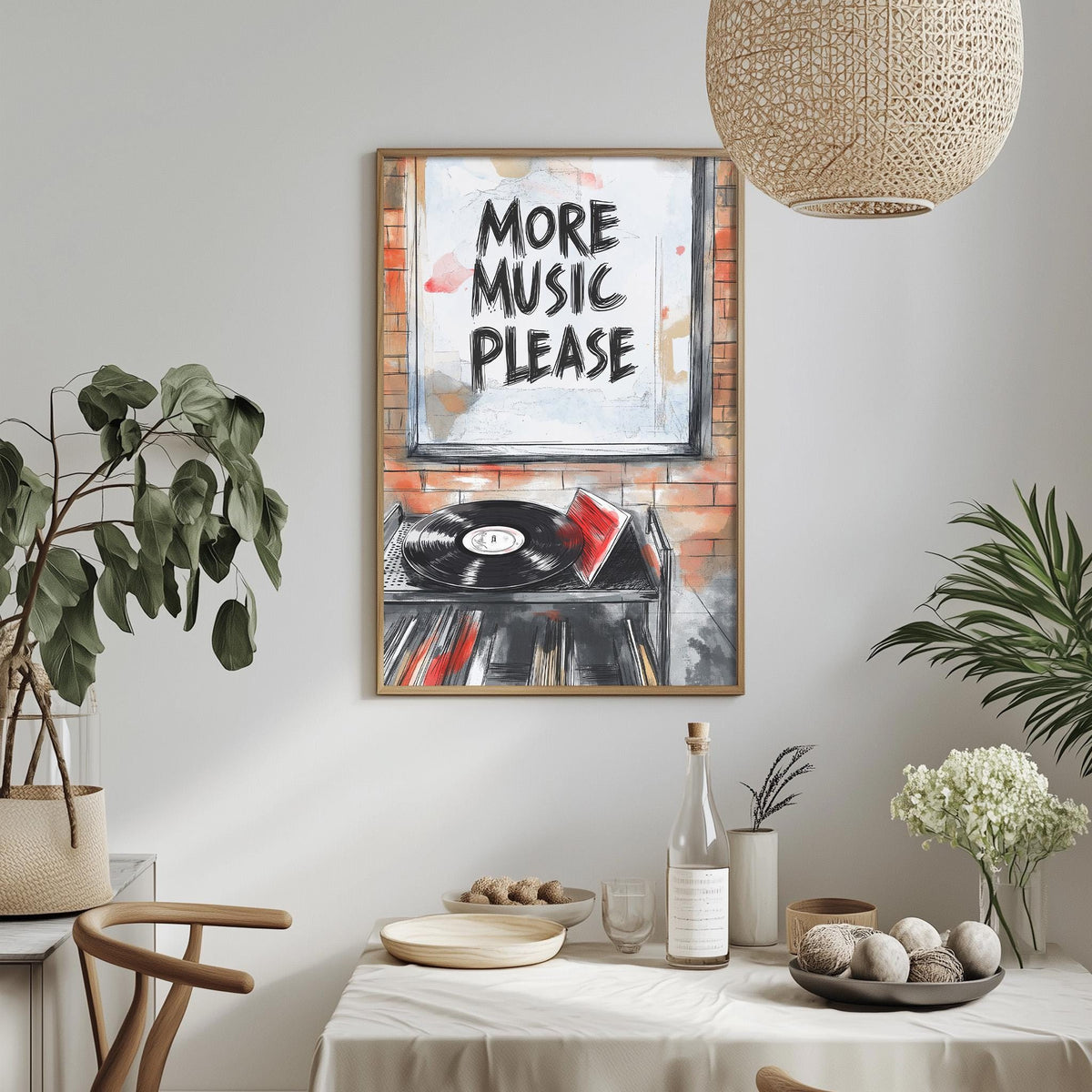 a framed poster with the text "MORE MUSIC PLEASE" hanging on a wall above a dining table with various items on it, including a bottle, bowls, and a vase.