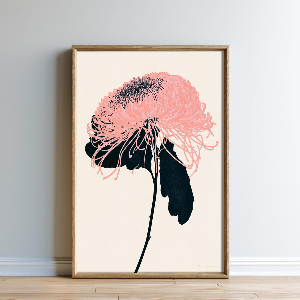 a framed artwork depicting a pink flower with black petals and a black stem.