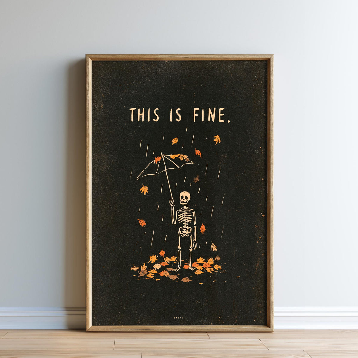 The image is a framed poster with a skeleton holding an umbrella and surrounded by falling leaves, with the text "THIS IS FINE."
