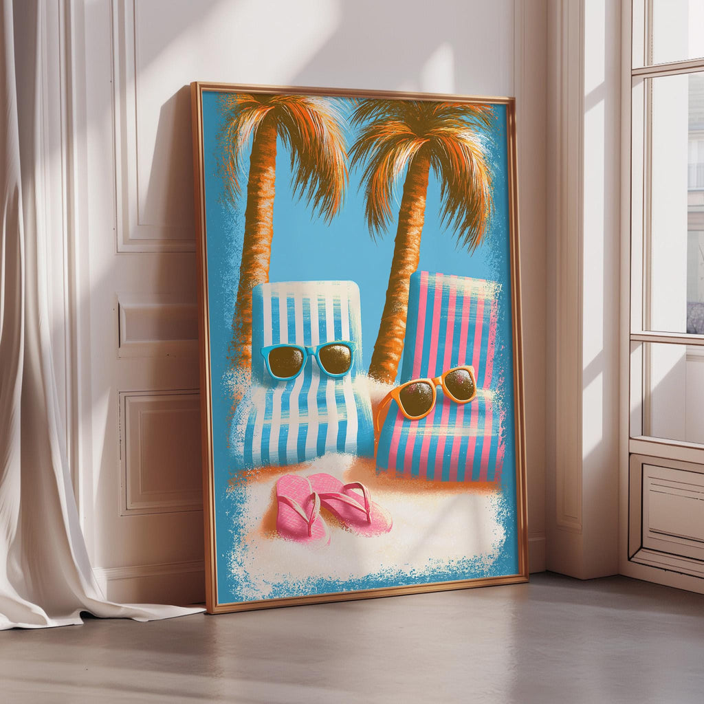 A framed poster depicting two beach chairs with sunglasses on them, set against a backdrop of palm trees and a blue sky.