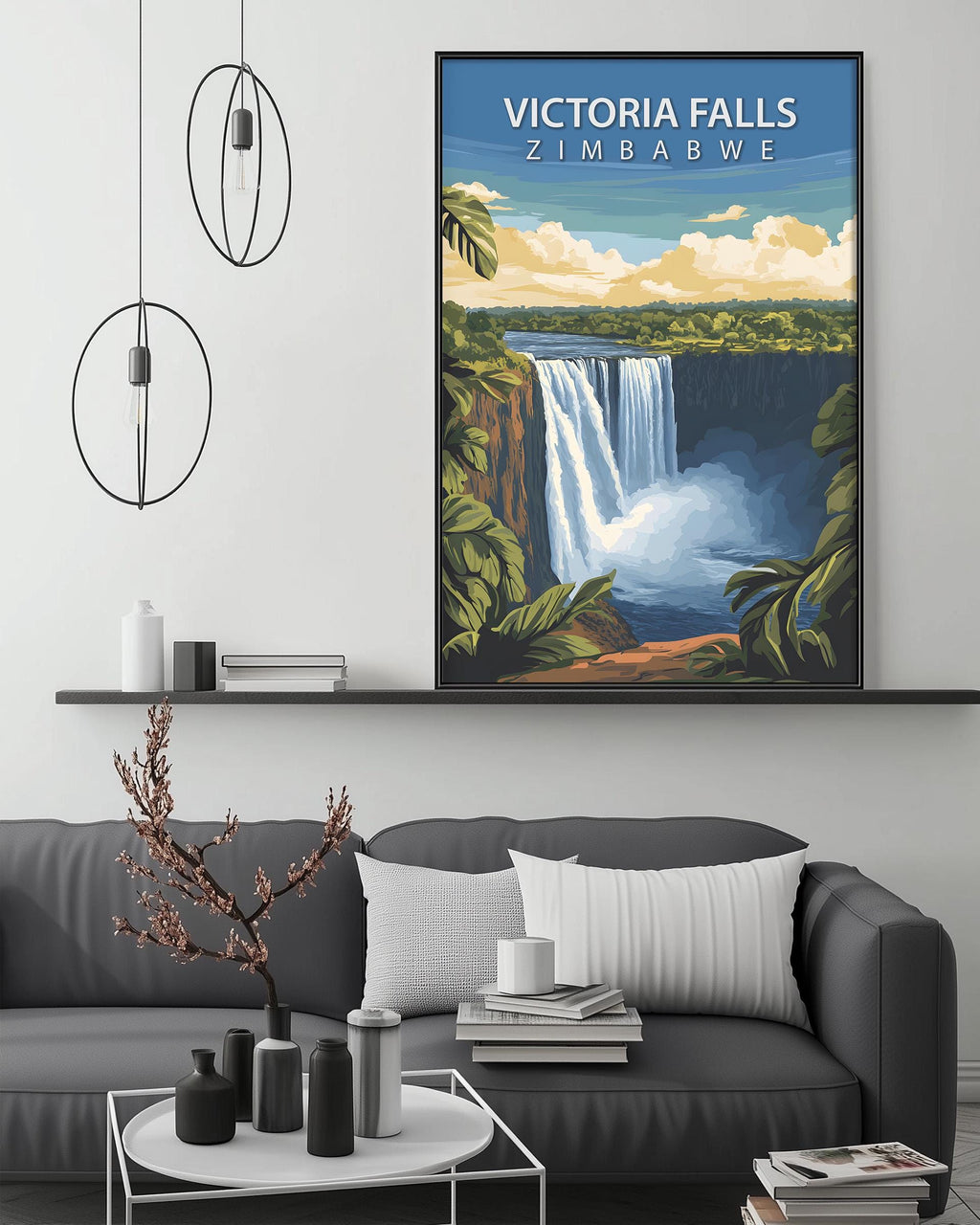 a large framed poster of Victoria Falls hanging on a wall above a gray couch in a living room setting.