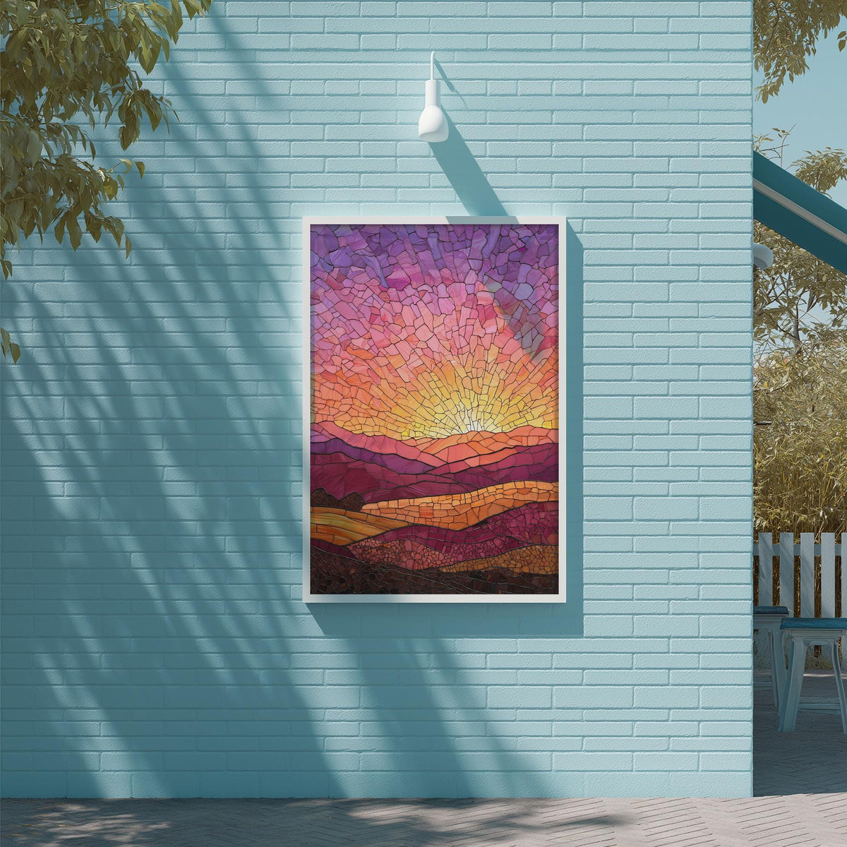 a vibrant stained glass artwork depicting a sunset over a mountainous landscape, mounted on a blue wall.