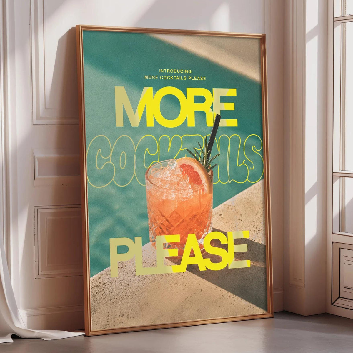 a poster with a large, colorful design that includes a cocktail glass and the text "MORE COCKTAILS PLEASE" prominently displayed.