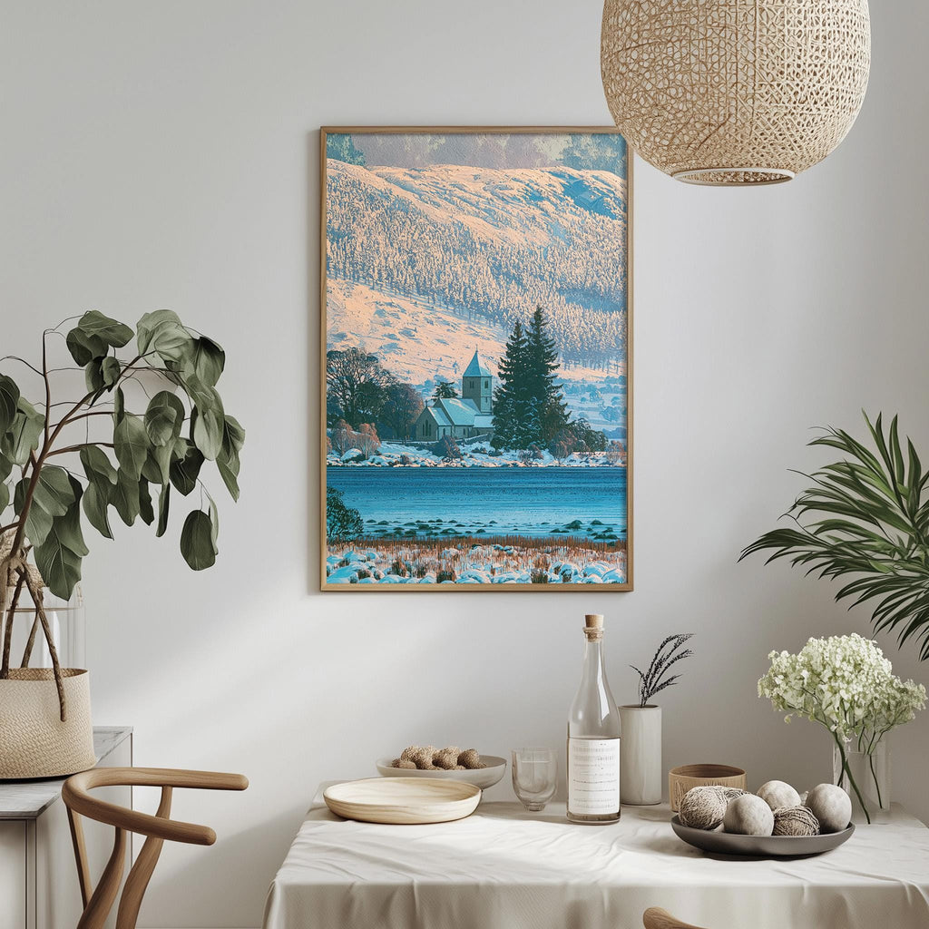 a dining table with a white tablecloth, a vase of white flowers, a bottle, and a bowl of fruit. Above the table, there is a framed picture of a snowy mountain landscape with a church in the distance.