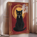A framed illustration of a black cat sitting on a red background, with a yellow sunburst design in the center.