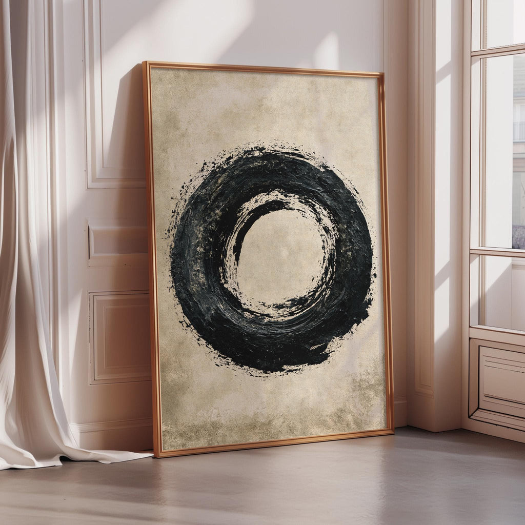 a large, framed artwork depicting a black circular design on a beige background.
