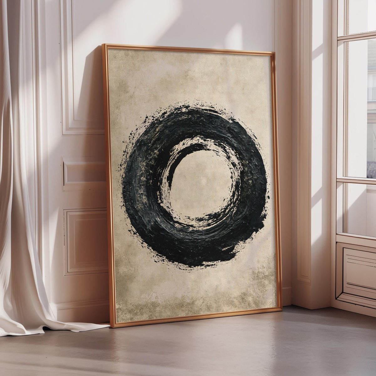 a large, framed artwork depicting a black circular design on a beige background.