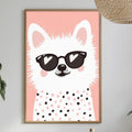 a framed picture of a cat wearing sunglasses, which is hanging on a wall above a dining table with various decorative items and plants.