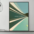a modern living room with a gray sofa, a coffee table, and a framed poster on the wall. The poster has a green and white abstract design and the text "GOOD GAME" written in white.