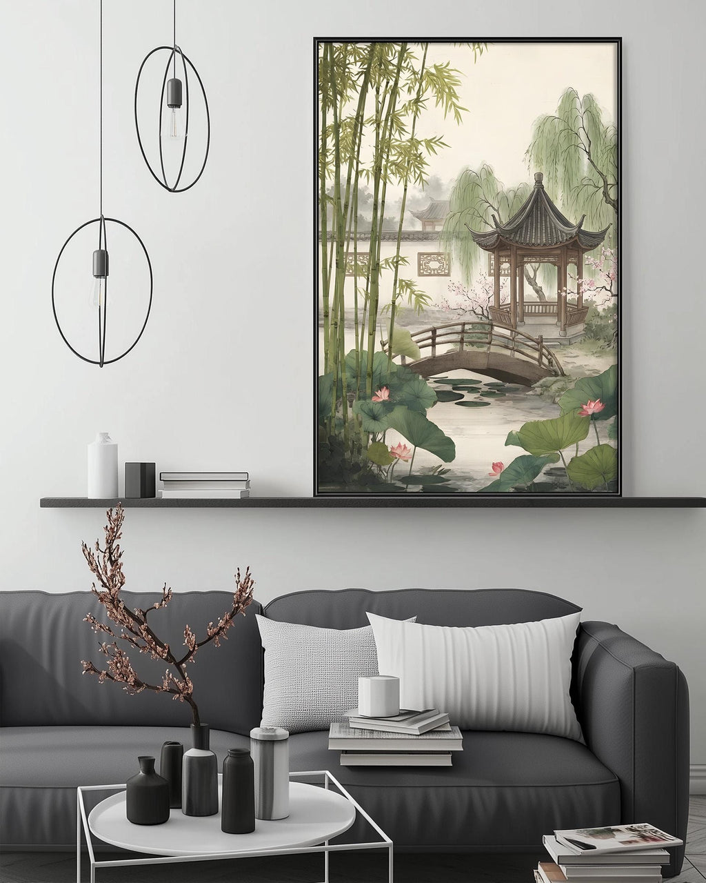 a living room with a gray sofa, a coffee table, and a large framed painting of a serene garden scene with a pagoda and a bridge.