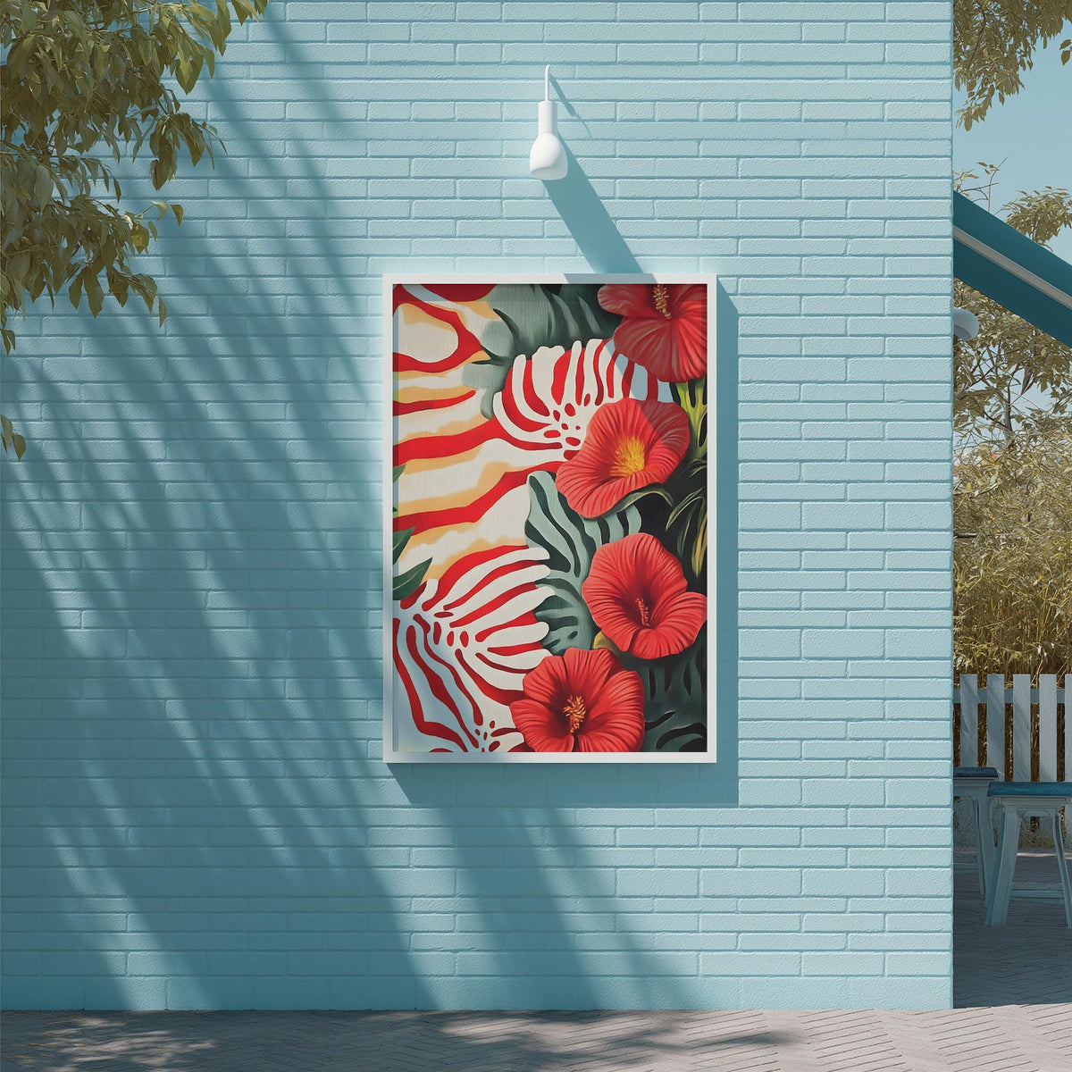 a vibrant painting of red and green tropical flowers, hanging on a blue wall.