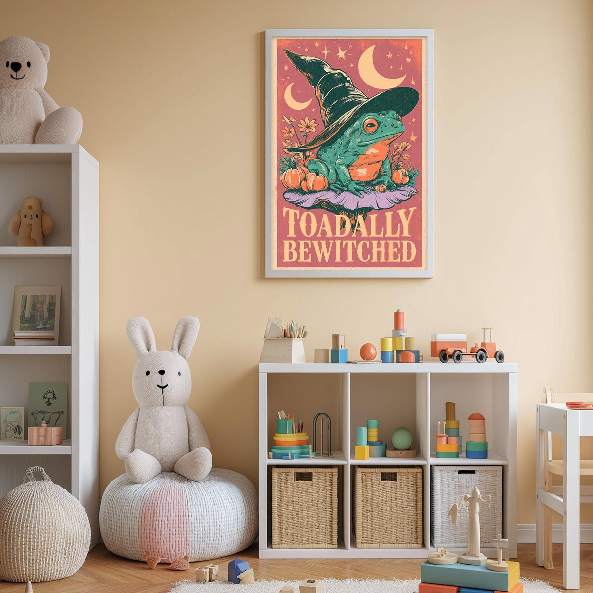 A child's bedroom with a white bookshelf, a stuffed rabbit, and a framed poster featuring a frog wearing a witch's hat.