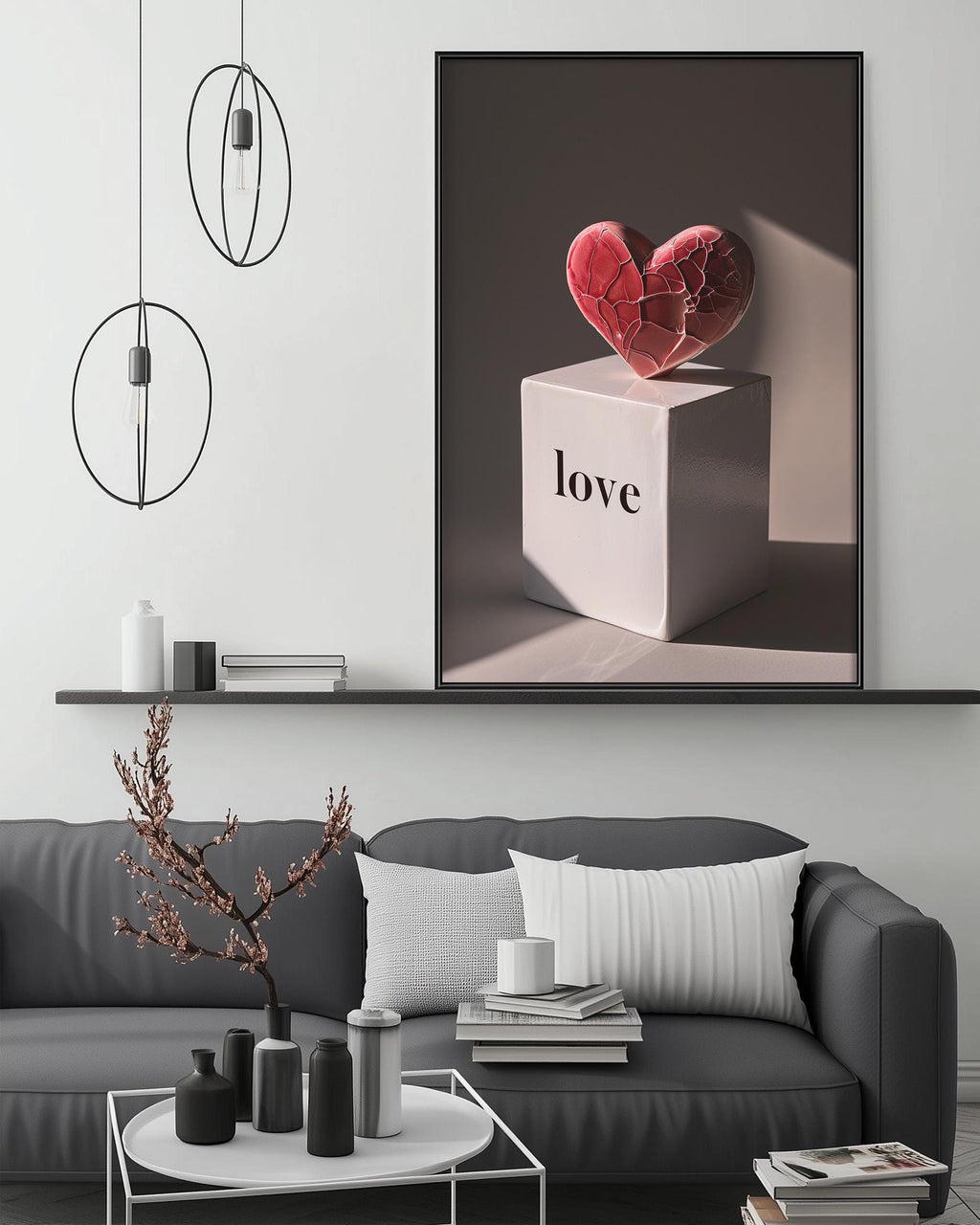 a modern living room with a gray sofa, a coffee table, and a large framed artwork depicting a heart-shaped object with the word "love" written on it.