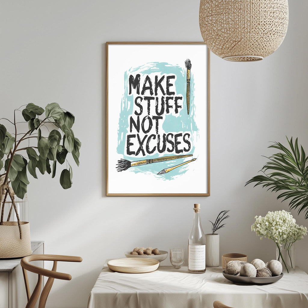 a framed poster with the text "MAKE STUFF NOT EXCUSES" hanging on a wall above a dining table with various items on it.