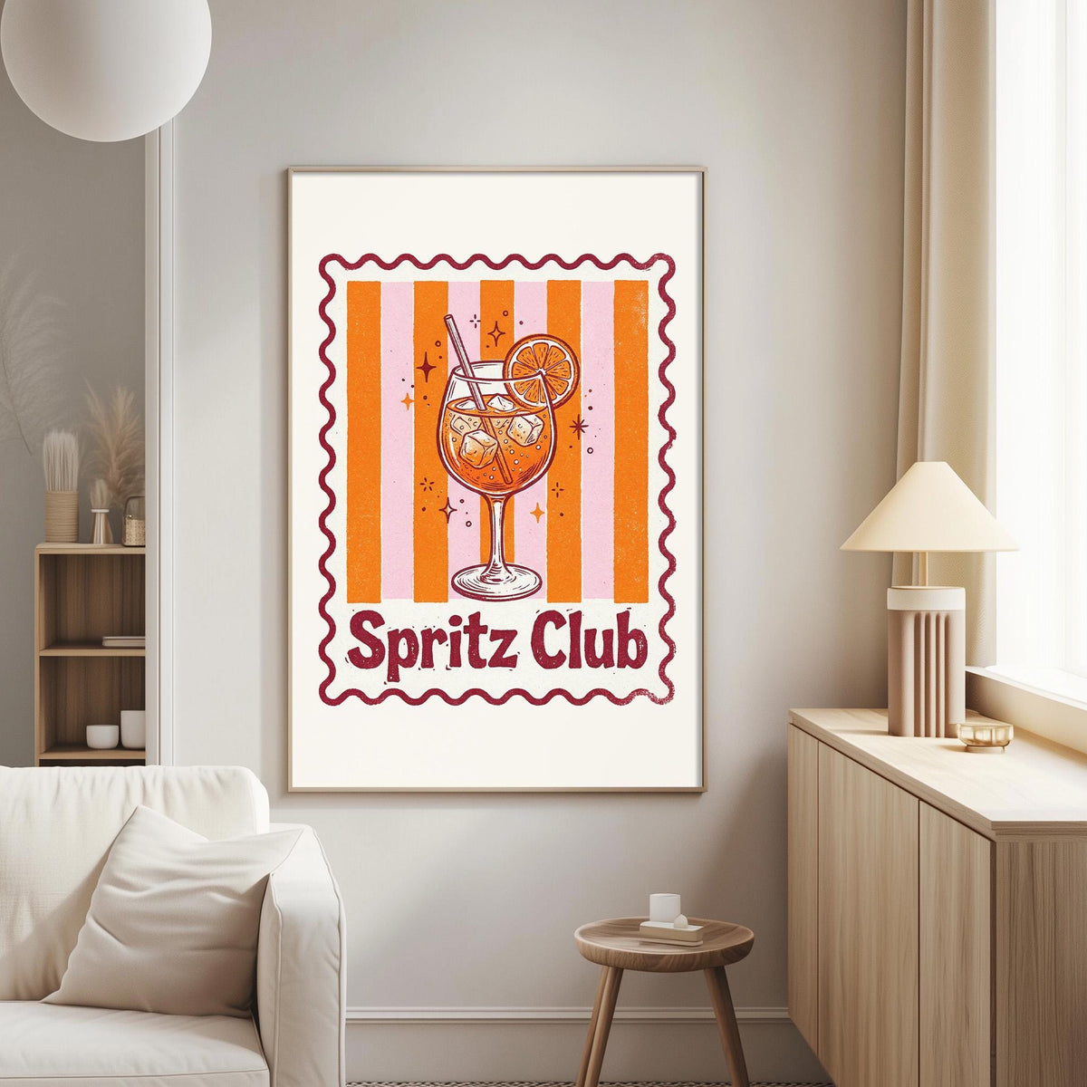 a framed poster of a glass of orange drink with a lemon slice, hanging on a wall in a living room.