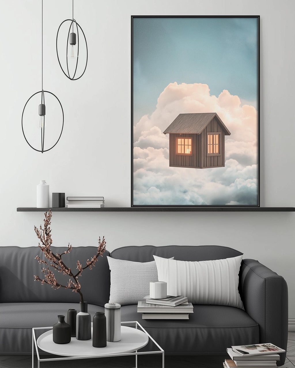 a cozy living room with a gray sofa, a coffee table, and a large framed picture of a house floating in the clouds above it.