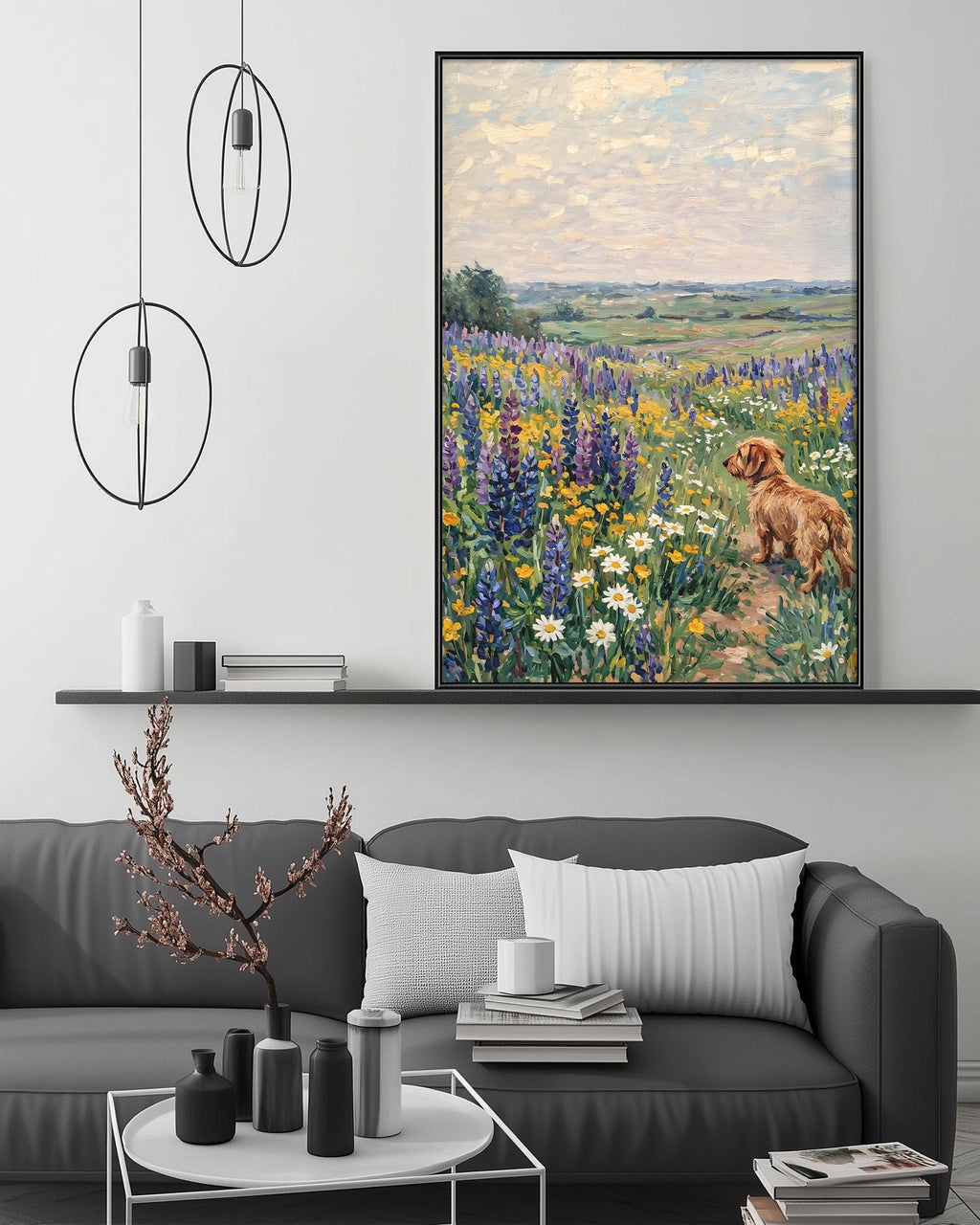 a large painting of a dog in a field of flowers hanging on a wall above a gray couch with white pillows.