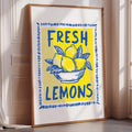 A framed poster with the text "FRESH LEMONS" and an illustration of lemons in a bowl.