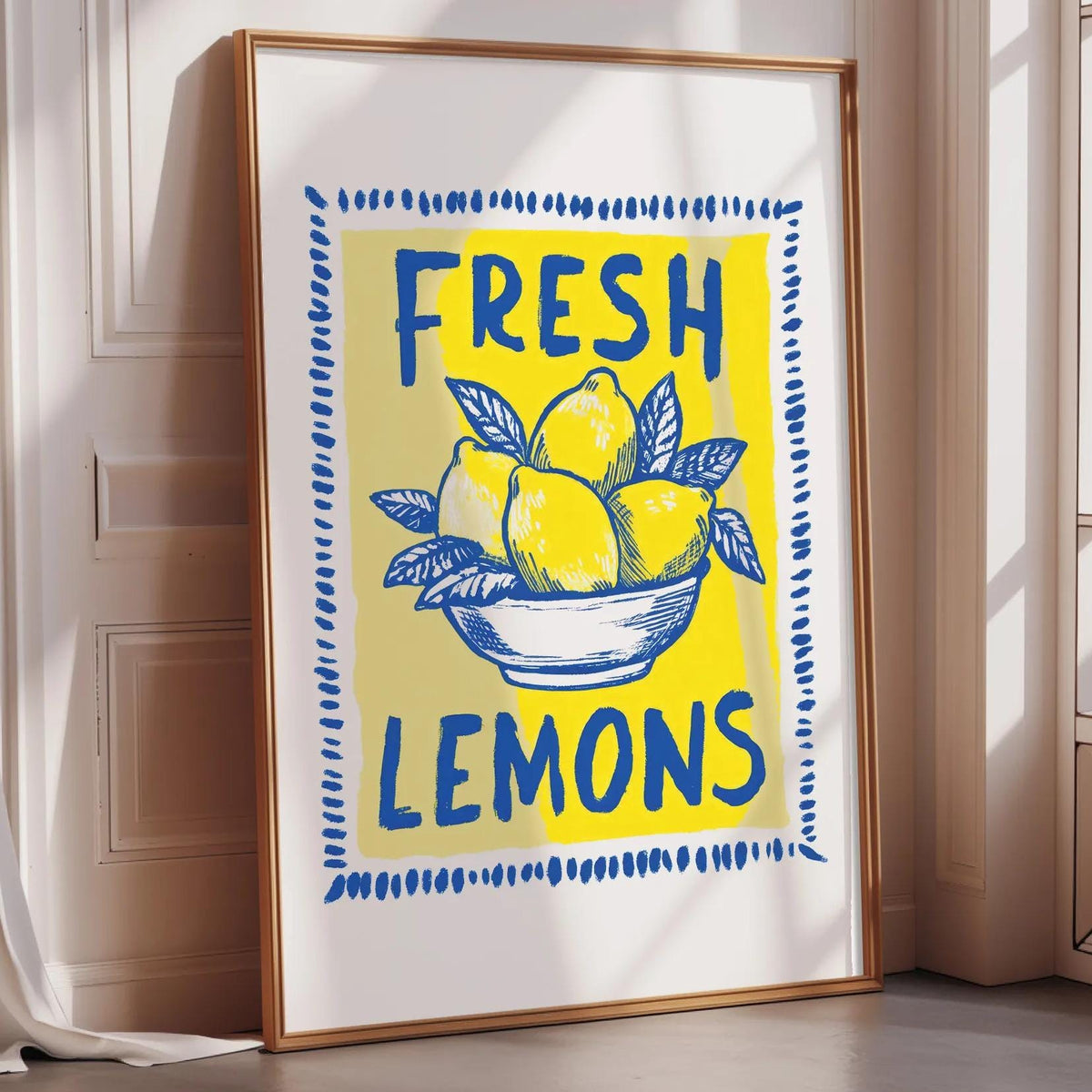 A framed poster with the text "FRESH LEMONS" and an illustration of lemons in a bowl.