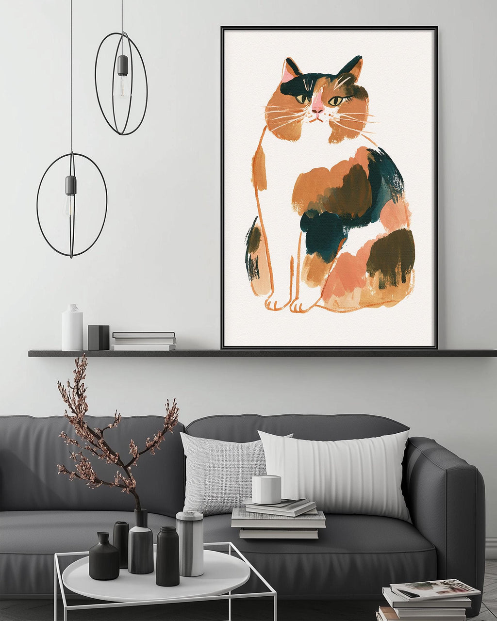 a large framed illustration of a cat sitting on a white background, hanging on a wall above a gray couch with white pillows.