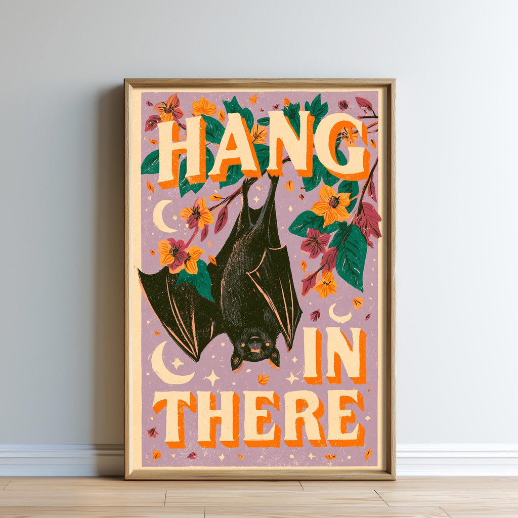 The image is a framed poster with a bat illustration and the text "HANG IN THERE" written in large letters.