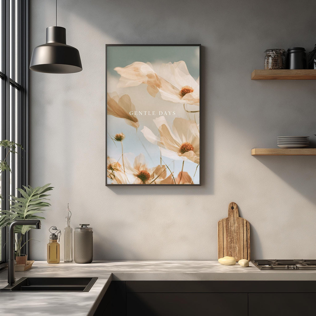 a kitchen counter with a framed picture of flowers hanging above it, along with various kitchen items such as a cutting board, a soap dispenser, and a plant.