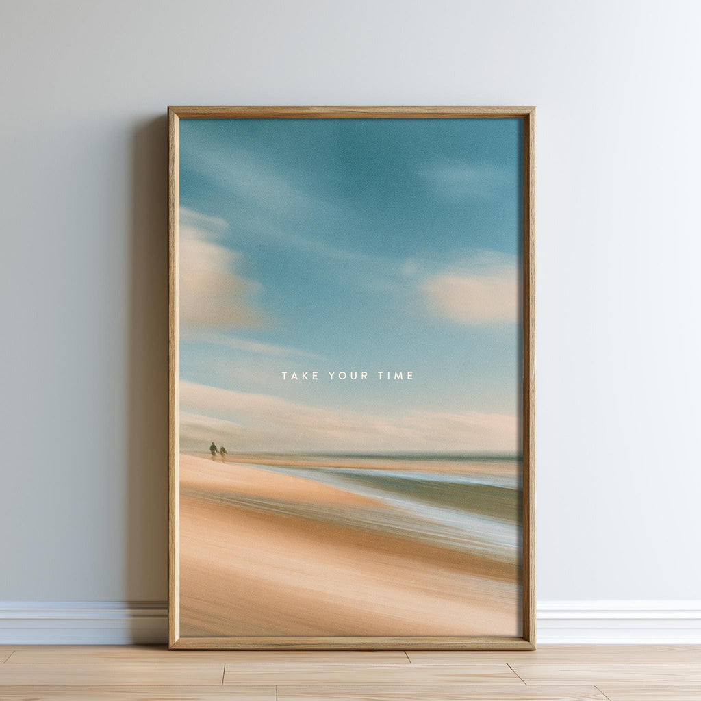 The image is a framed print of a beach scene with a cloudy sky, featuring a couple walking along the shoreline.