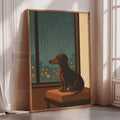 A framed illustration of a dog sitting on a bench, looking out a window at a rainy cityscape.