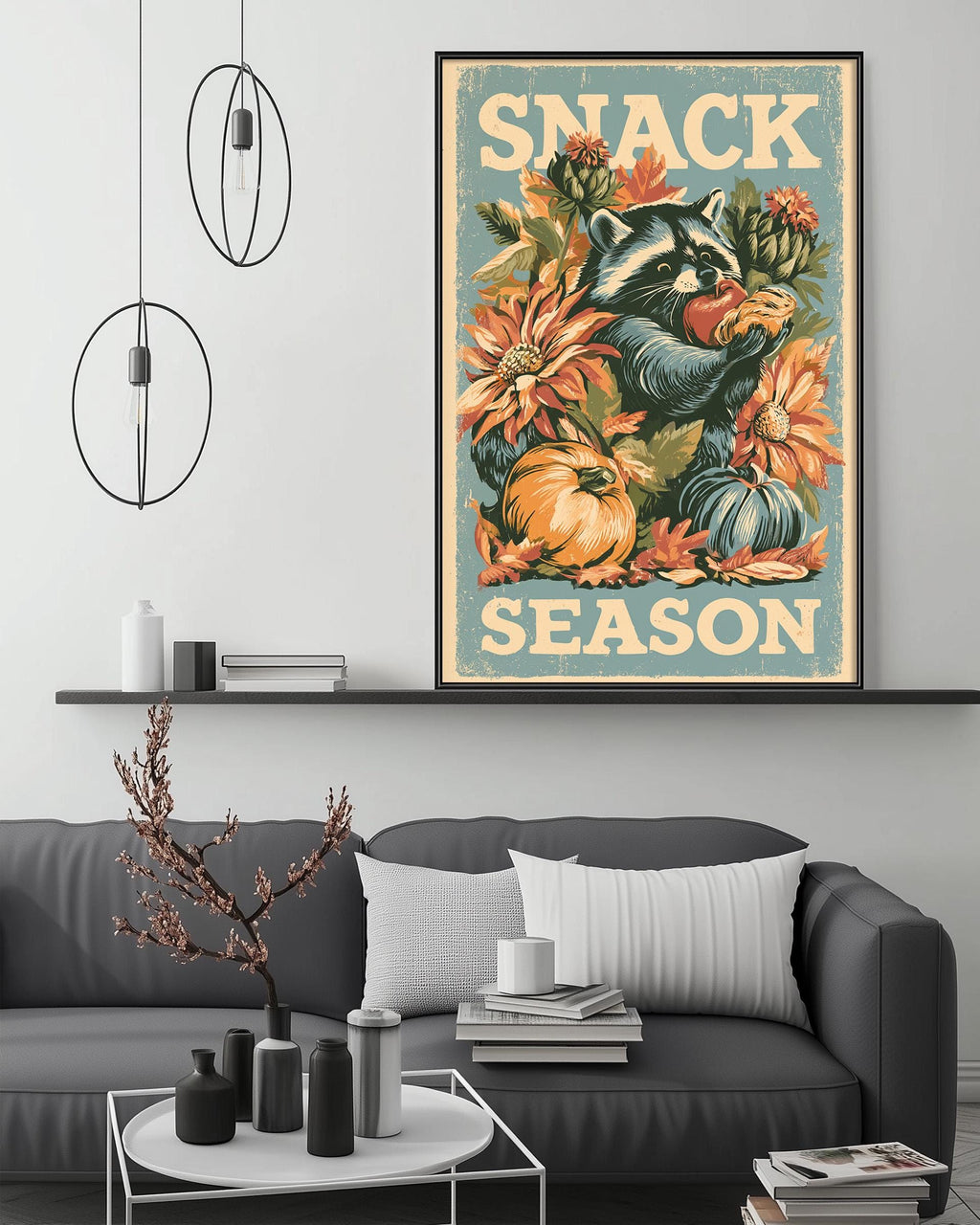 a cozy living room with a gray couch, a coffee table, and a framed poster of a raccoon eating a flower on the wall.