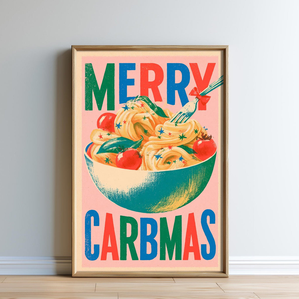 A framed poster with a colorful illustration of a bowl of pasta and various vegetables, along with the text "MERRY CARBMAS" displayed prominently.