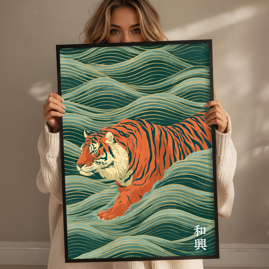A woman is holding up a framed poster with a tiger illustration on it.