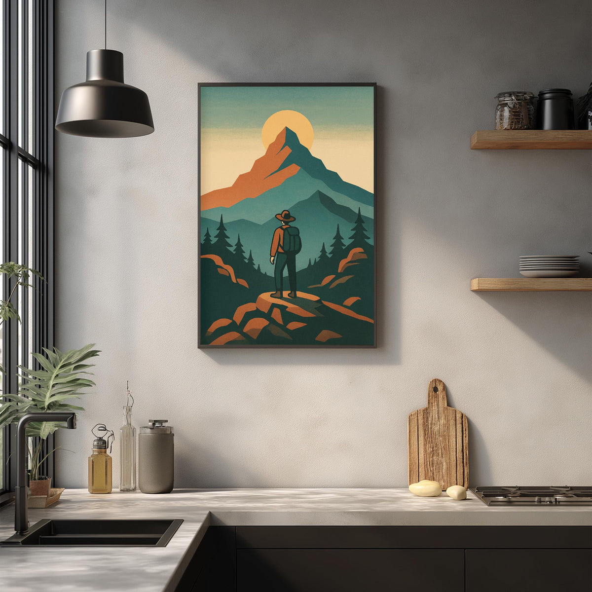 a framed illustration of a hiker standing on a mountain peak, with a sunset in the background. The hiker is wearing a backpack and appears to be looking out over the landscape. The kitchen counter in the foreground has various items on it, including a cutting board, a bottle, and a vase.