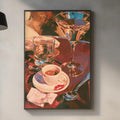 a kitchen counter with various items, including a framed painting of a glass of wine, a coffee cup, a wine glass, a cutting board, and some kitchen accessories.