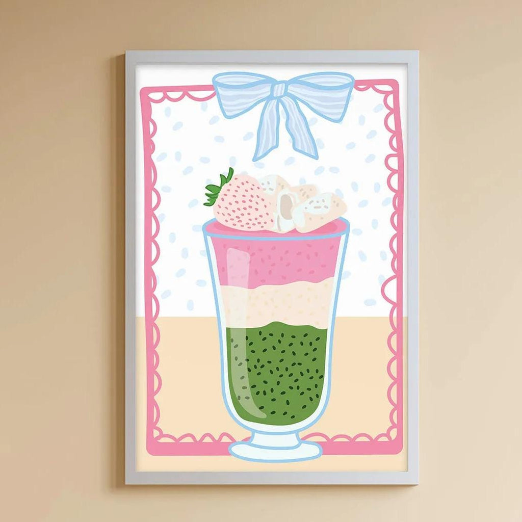 A cozy children's room with a white bookshelf, a plush rabbit, and a colorful toy box filled with toys. A framed illustration of a layered drink with a strawberry on top is displayed on the wall above the toy box.