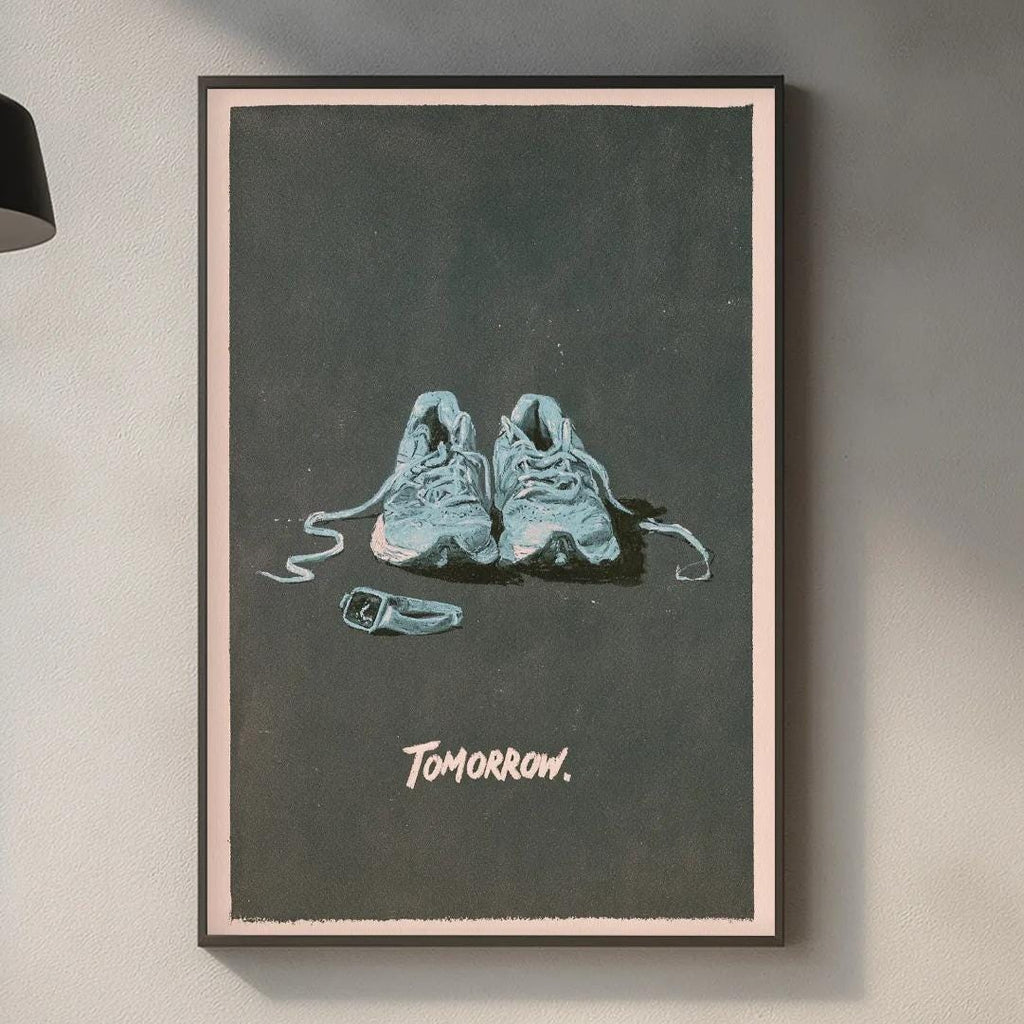 a framed poster of two shoes on a wall, with the word "tomorrow" written below the shoes.
